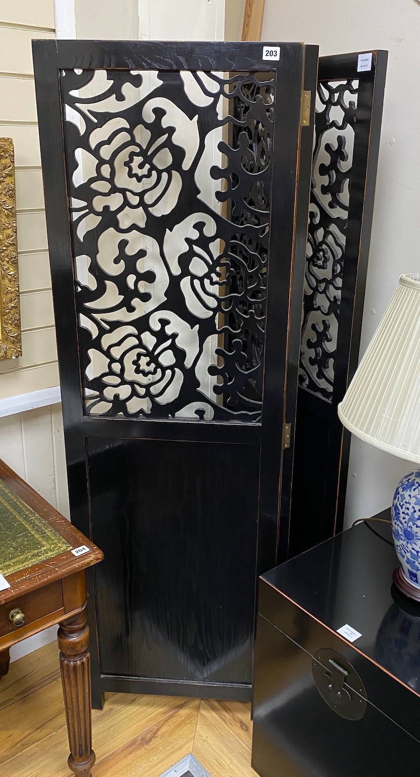 A Chinese ebonised three fold draught screen, each panel width 52cm, height 171cm